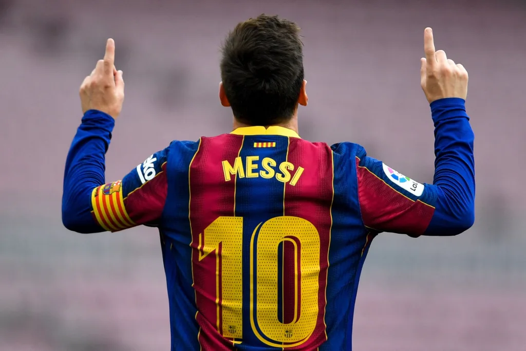 Lionel Messi doing his signature celebration with his Barcelona shirt