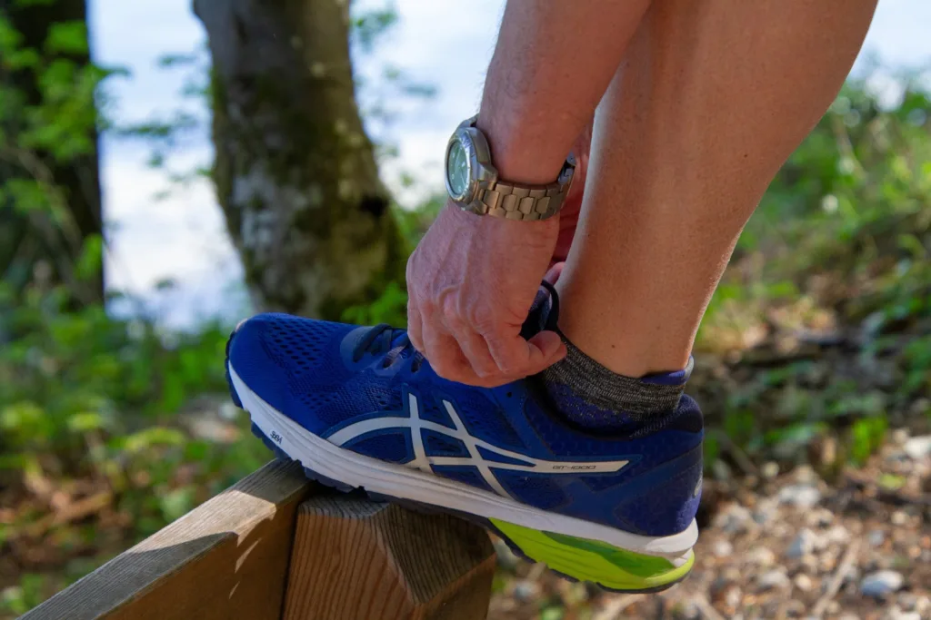 A person tying his best running shoes