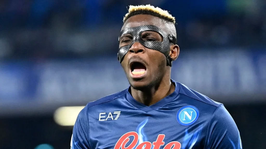Osimhen wearing his face mask, his celebrating after scoring a goal for Napoli