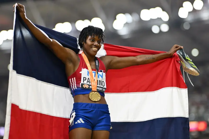 Marileidy Paulino with the World Athletics Championships golden medal and the Dominican Republic Flag after winning in 2023