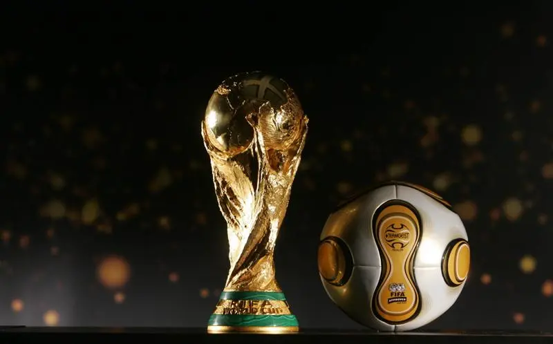 The 2030 World Cup trophy and a ball of a past edition of the World Cup