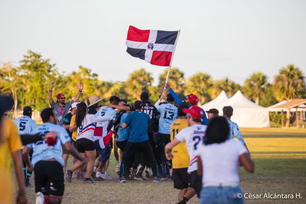 The Dominican Republic flag in the middle of Blue Devils celebration after the last point to win the championship in the 2023 PAUC
