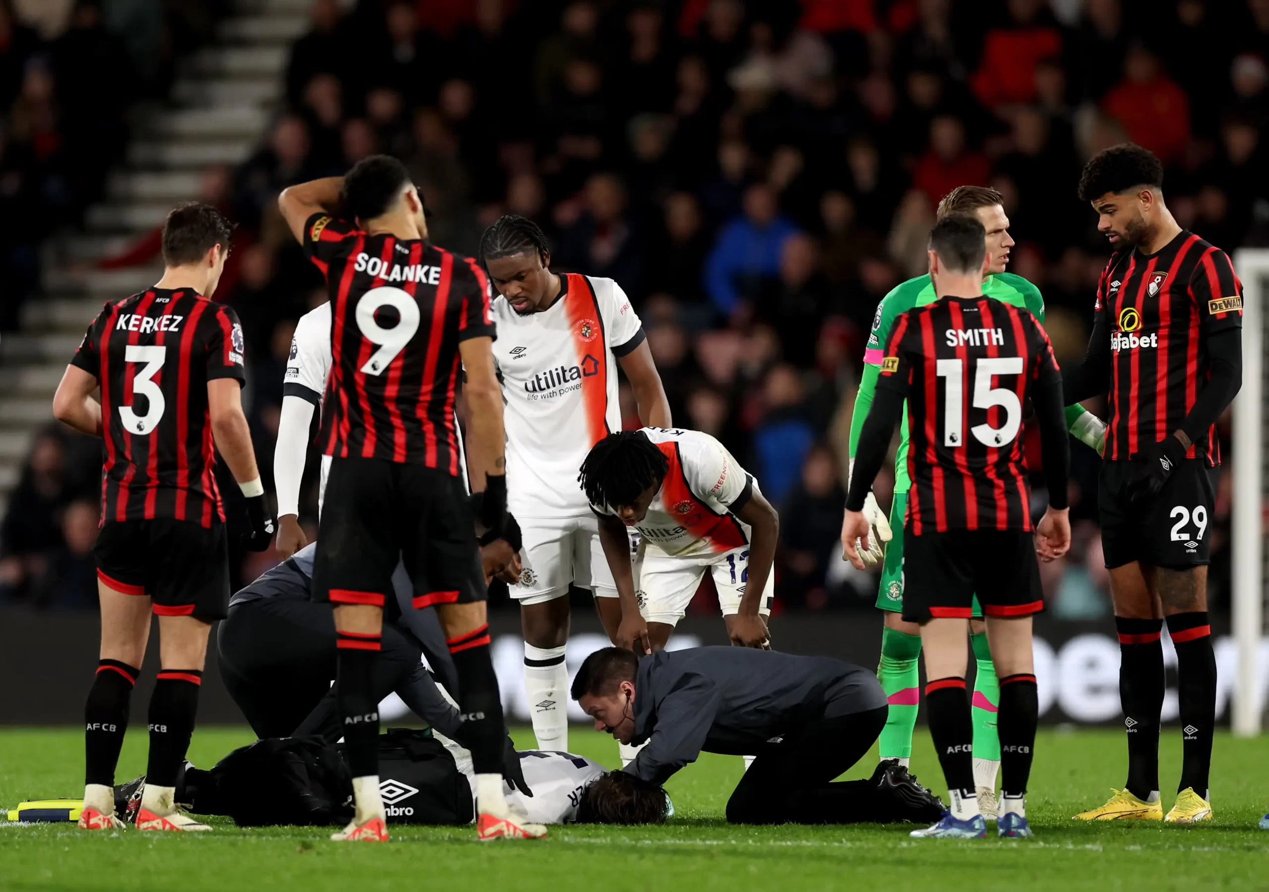 Luton Town and Bournemouth players around Tom Lockyer after he suffered a cardiac arrest mid game