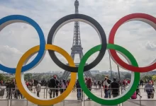 Paris Olympic rings in front of the Eiffel Tower announcing that there will be 300000 condoms available in the olympic village for athletes